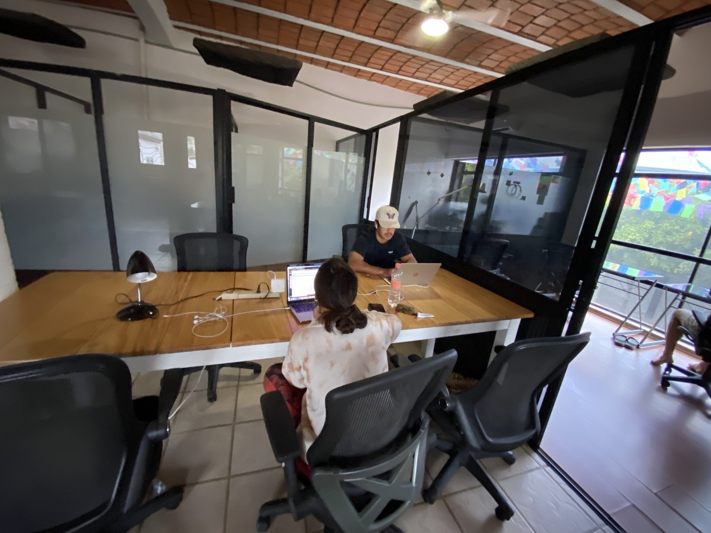 Members working at the shared table inside Sayulita Cowork
